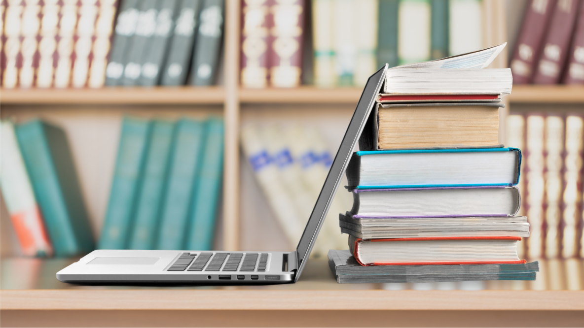 pile of books next to computer - world book day career future