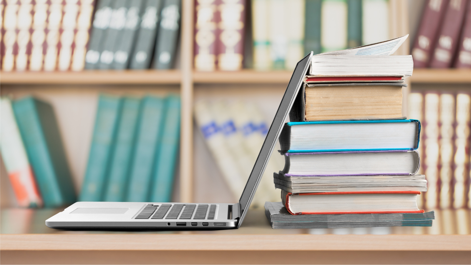 pile of books next to computer - world book day career future