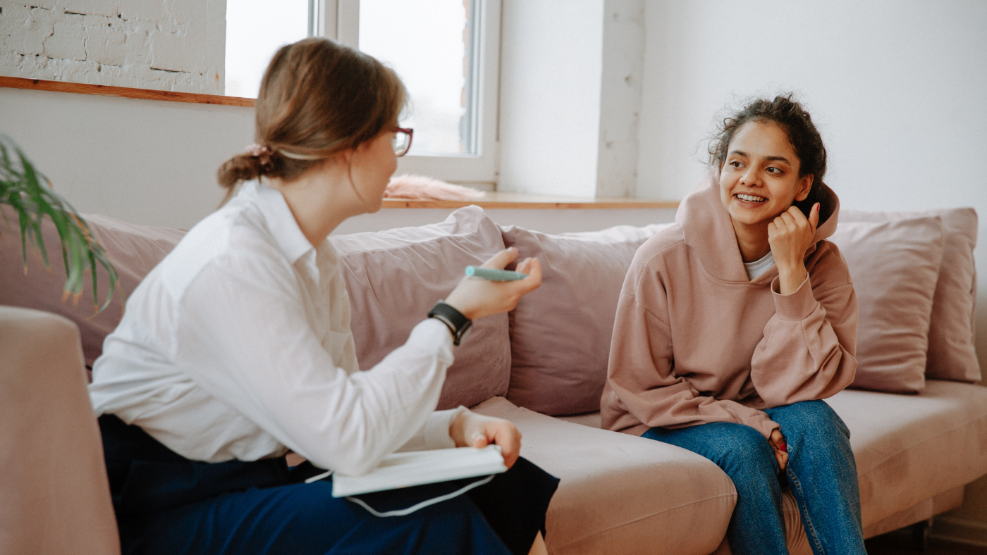 HR sitting on couch talking to employee